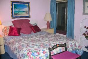 a bedroom with a large bed and a chair at Bay Princess 103 in Ocean City