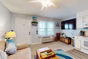 a living room with a couch and a kitchen at Sea Nymph in Ocean City
