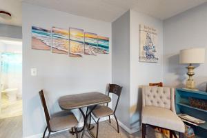 a dining room with a table and two chairs at Sea Nymph in Ocean City