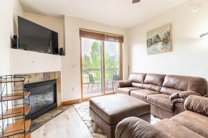 a living room with a couch and a fireplace at Highland Greens Lodge #311 in Breckenridge