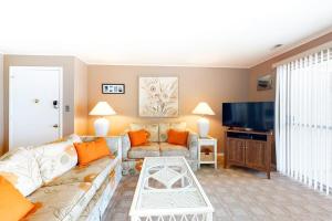 a living room with a couch and a tv at Thunder Island 28A in Ocean City