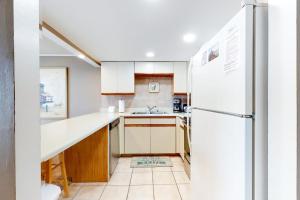 a kitchen with white appliances and a white refrigerator at Thunder Island 28A in Ocean City +11 photos