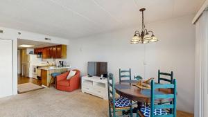 a kitchen and dining room with a table and chairs at White Marlin 105B in Ocean City