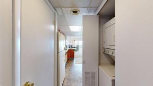 a hallway leading to a kitchen with white walls at White Marlin 105B in Ocean City +12 photos