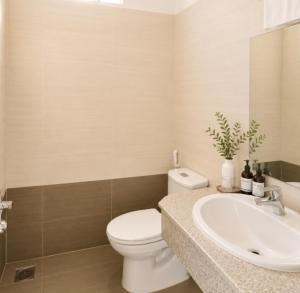 a bathroom with a white toilet and a sink at Atusy Hotel in Ho Chi Minh City +18 photos