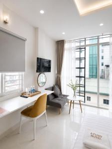 a living room with a couch and a table at Atusy Hotel in Ho Chi Minh City