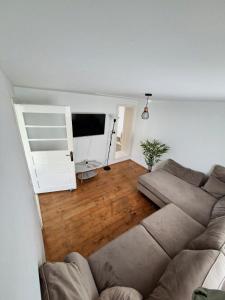 a living room with a couch and a flat screen tv at Casa Noastra in Drajna de Sus