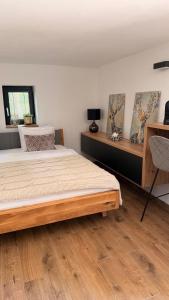 a bedroom with a bed and a wooden floor at Chata 01 in Čeladná