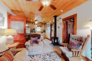 a living room with a couch and chairs and a kitchen at Hazen's Hideaway in North Hero +56 photos