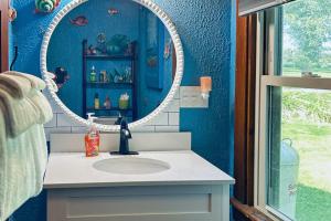 a bathroom with a sink and a mirror at Hazen's Hideaway in North Hero
