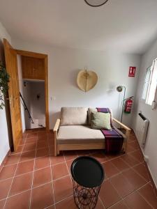 a living room with a couch on a tiled floor at La Casita de Sara in Cercedilla