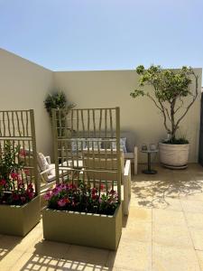 three planters with flowers in them on a patio at Villa Populo in Ponta Delgada