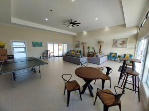 a living room with a ping pong table and chairs at Hamilton @ Oceanpointe a serene 2bed 2 bath Villa in Lucea