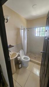 a bathroom with a toilet and a sink and a shower at Habitaciones Casa Cuscatlan in Tamanique +73 photos