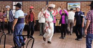 a group of people standing on a dance floor at Hostería en Chachimbiro - Ariq in Hacienda San Francisco