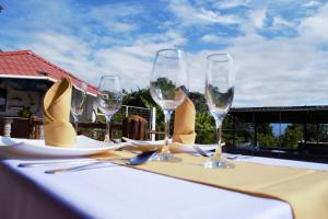a table with four wine glasses on top of it at Hostería en Chachimbiro - Ariq in Hacienda San Francisco