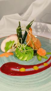 a plate of food with vegetables on a plate at Hostería en Chachimbiro - Ariq in Hacienda San Francisco +19 photos