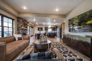 a living room with a couch and a table at Branson 10 Bedroom Lakeside Lodge! PRIVATE HEATED POOL! in Hollister