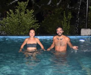 a man and a woman in a swimming pool at Hostería en Chachimbiro - Ariq in Hacienda San Francisco