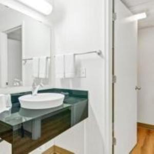 a white bathroom with a sink and a mirror at Big Springs Inn in Big Springs +17 photos