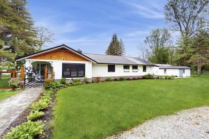 a white house with a grass yard at Shore Acres in Isle la Motte