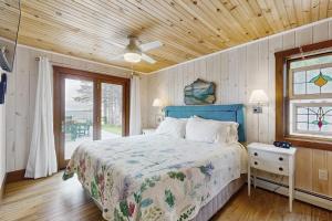 a bedroom with a bed and a wooden ceiling at Shore Acres in Isle la Motte