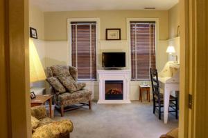 a living room with a fireplace and a tv at Apple Bin Inn in Willow Street