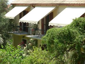 an apartment building with balconies and trees at Trifilli in Lourdata
