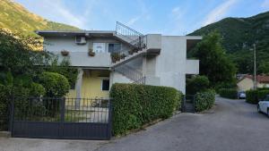 a house with a staircase on the side of it at Apartments MiMa in Kotor