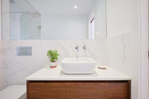 a white bathroom with a sink and a tub at Dreamy Sea View Balcony in Algés +110 photos