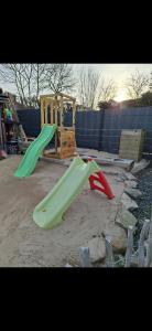 two green and red slides in a playground at Haus am Vogelsang in Hannoversch Münden