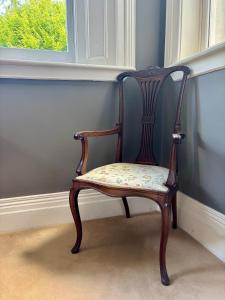 a wooden chair sitting in a room next to a window at Blackhill Woods Retreat in Abbeyleix +46 photos