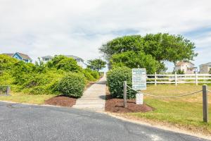 a walkway with a sign next to a house at 4218 - The Scotts' SandBar in Duck