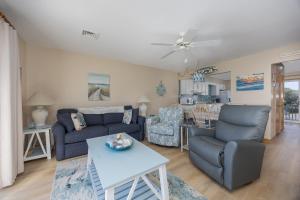 a living room with a couch and a table at 4218 - The Scotts' SandBar in Duck