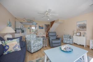 a living room with a couch and chairs and a table at 4218 - The Scotts' SandBar in Duck +36 photos