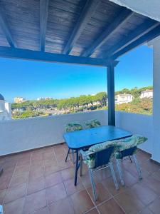 a blue table and chairs on a balcony with a view at BLUE Dreams in Mijas Costa