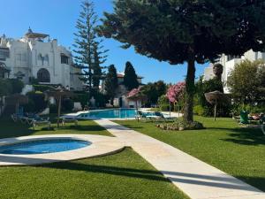 a yard with a swimming pool and a house at BLUE Dreams in Mijas Costa