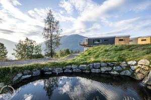 a house with a stone bridge over a pond at Possegger Hideaways in Zödl +40 photos