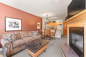 a living room with a couch and a fireplace at Silver Mill #8222 in Keystone