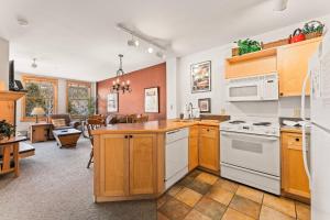 a kitchen with wooden cabinets and white appliances at Silver Mill #8222 in Keystone +29 photos