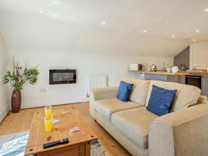 a living room with a couch and a table at 1 Bed in Taunton oc-87929 in Pitminster