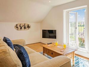 a living room with two couches and a coffee table at 1 Bed in Taunton oc-87929 in Pitminster