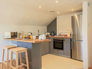 a kitchen with a stainless steel refrigerator and a counter at 1 Bed in Taunton oc-87929 in Pitminster +15 photos