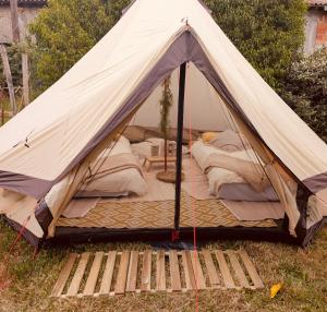 a tent sitting in the grass in a field at La Belle Verte in Laruscade