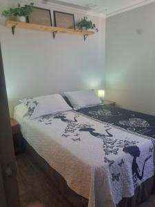 a bedroom with a bed with a blanket on it at Dpto santa rosa in Ovalle