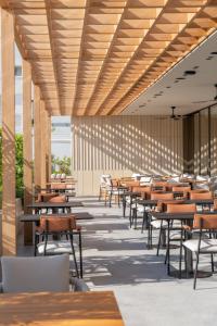 an empty restaurant with tables and chairs at The Nines in Ayia Napa