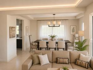 a living room and dining room with a couch and a table at Endless View Villa with Private Pool & BBQ in Daratso