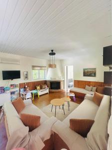 a living room with a couch and a table at Grandpa’s cottage in Nea Makri