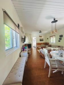a living room with a couch and a table and chairs at Grandpa’s cottage in Nea Makri