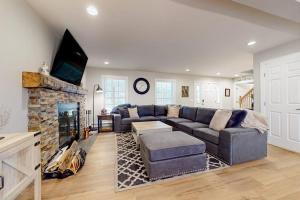 a living room with a couch and a fireplace at Modern Mountain Homestead in Dover